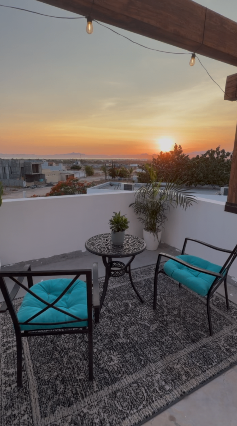 Rooftop bistro table with a view of the bay at sunset