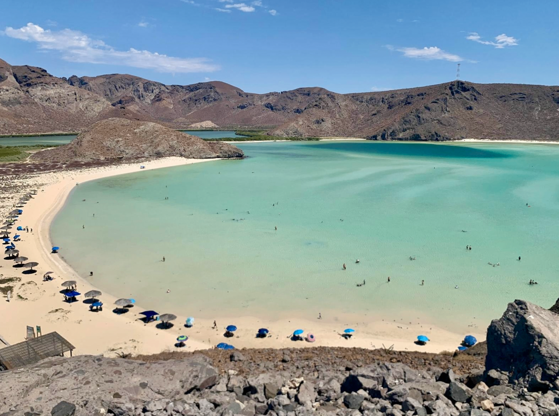 Aerial view of Balandra Beach with turquoise water and desert mountains