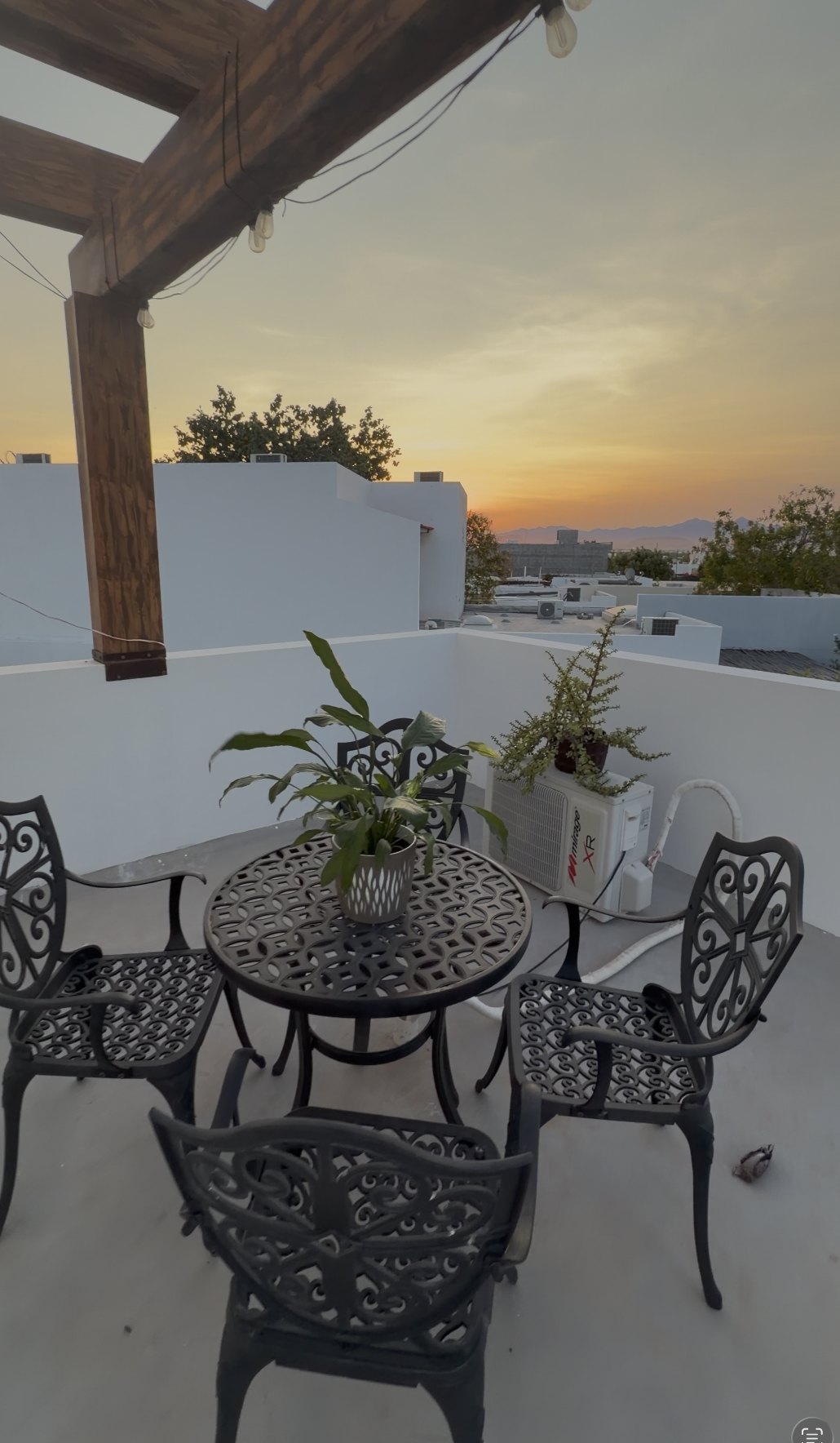 Rooftop bistro table at sunset over La Paz