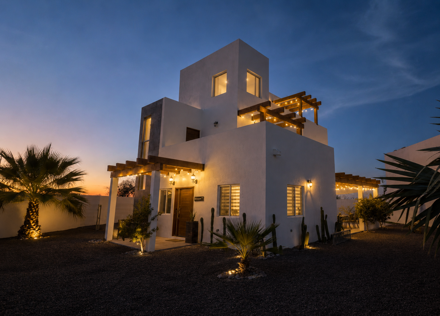Casa Claudia at nightfall with string lights lit beneath four pergolas across three floors