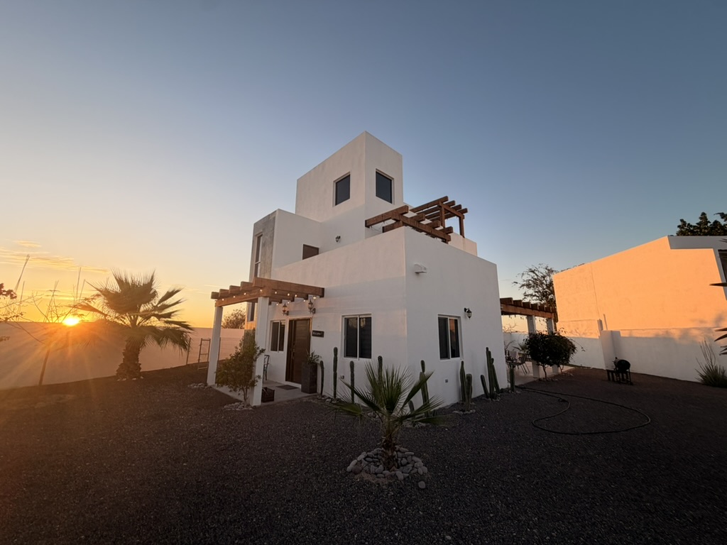 Casa Claudia at sunset — rooftop terrace over the desert