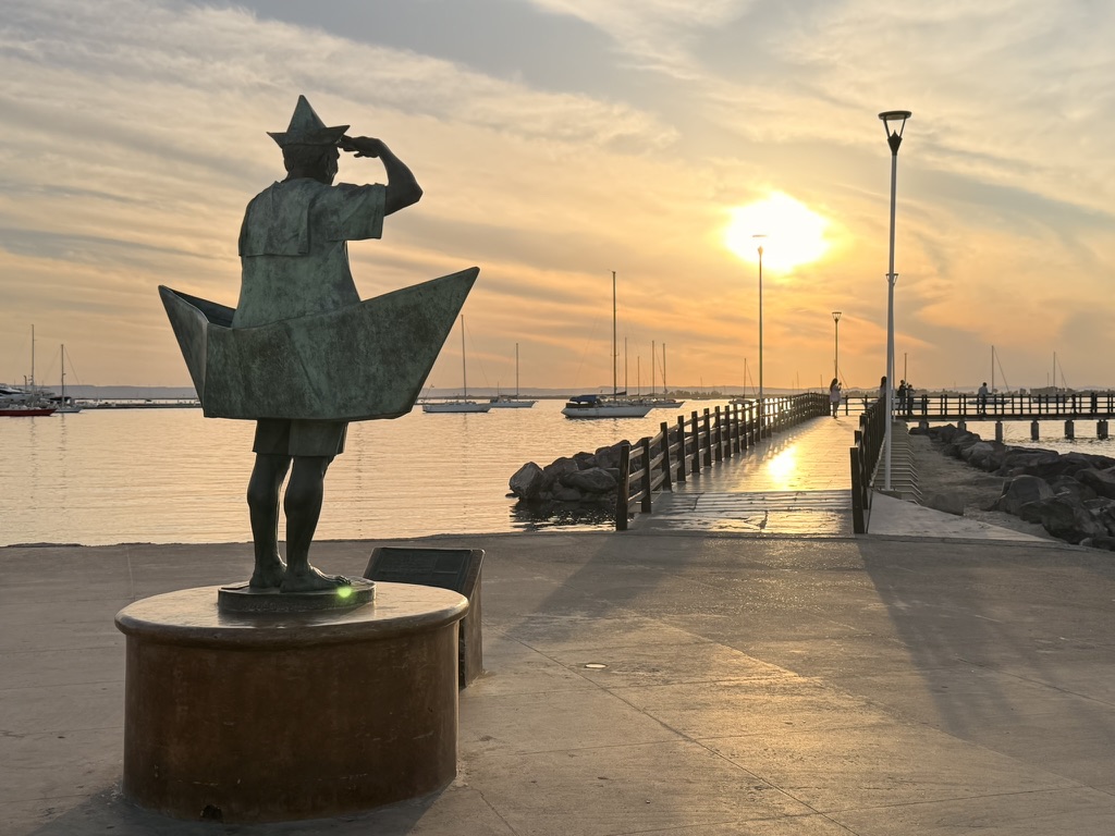 Sailor statue looking out over the La Paz marina at sunset